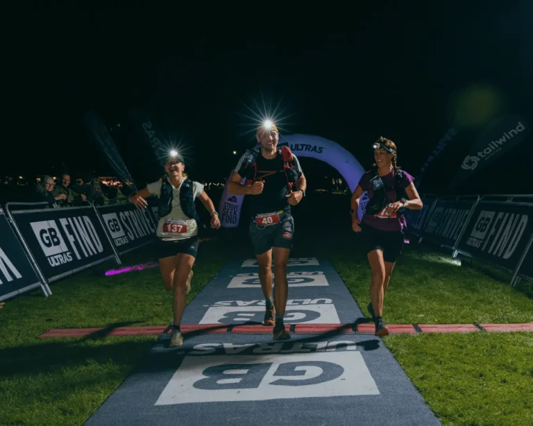 Kaylee crossing the finish line at a GB Ultras Snowdon event