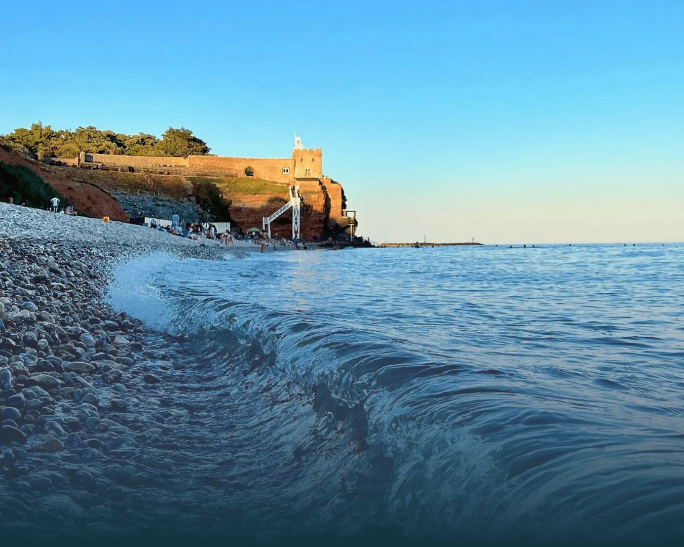 Wave breaking on a pebble beach at Sidmouth, Devon